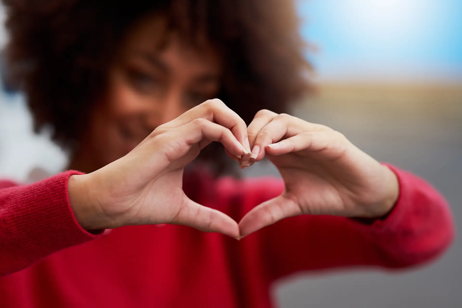 Woman making heart shape with hands